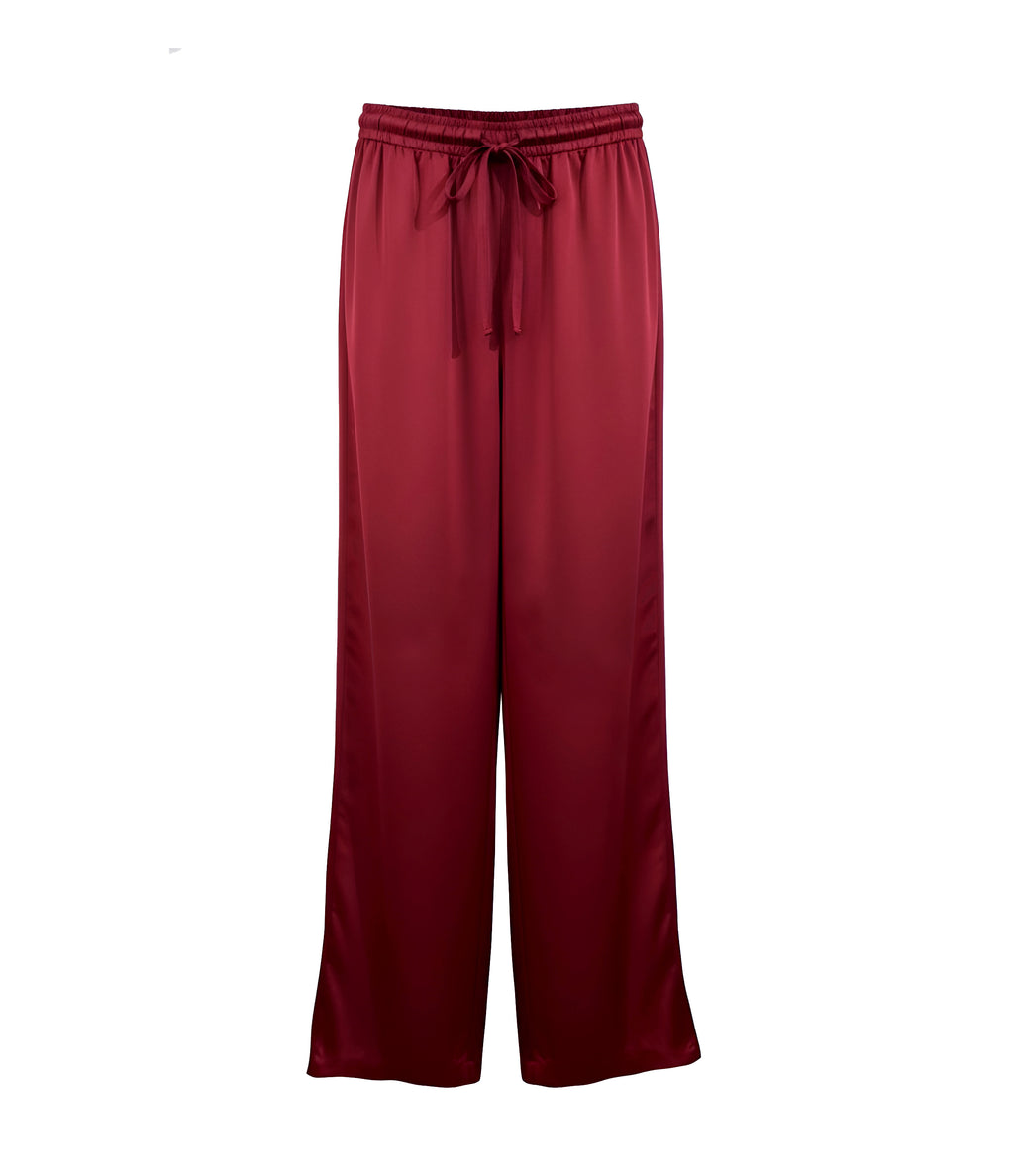 Maroon satin pants with a tie waist on a white background